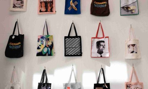 a bunch of bags hanging on a wall